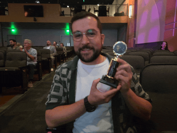 Ralph holding the Brat Snack award